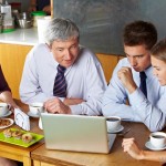 group-using-laptop-at-a-cafe